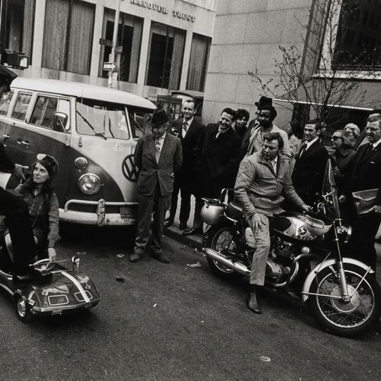 Untitled (woman in small car, VW van)