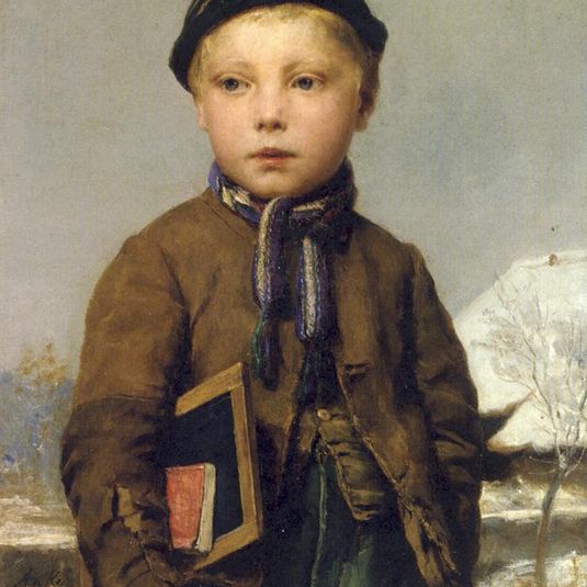 School boy with slate board in a snowy landscape