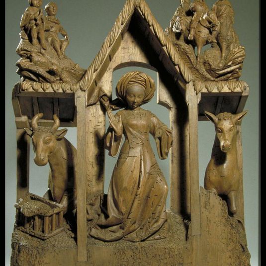 Midwife in the stable of the Nativity surmounted by the figures of the shepherds and the Magi
