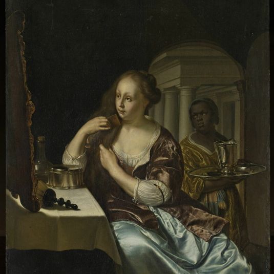 Woman combing her hair, assisted by a young black servant