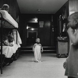 I rarely saw kids in the shelter play. Shelter life is a serious game. This baby waits anxiously for his mama to take him to bed. Olive Branch Mission, Chicago.