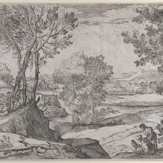 A family seated alongside a river