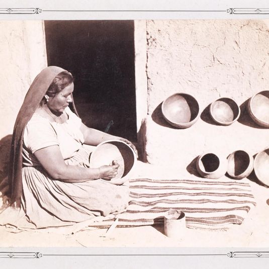 Woman Polishing Pottery
