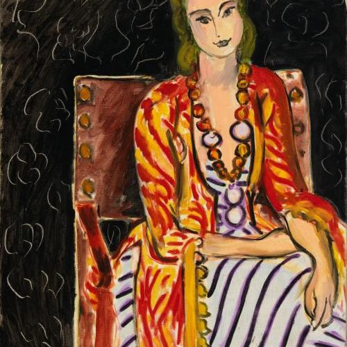 ASL: Woman Seated before a Black Background