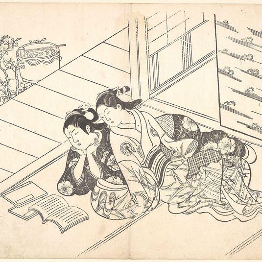 Two Women Reclining on the Floor of a Room and Reading a Book